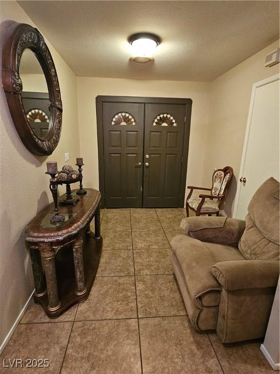 7104 Carrondale Way, Las Vegas, NV 89128 - foyer entrance with a textured ceiling, tile patterned flooring, and baseboards