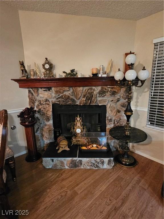 7104 Carrondale Way, Las Vegas, NV 89128 - detailed view of wood finished floors, a fireplace, baseboards, and a textured ceiling