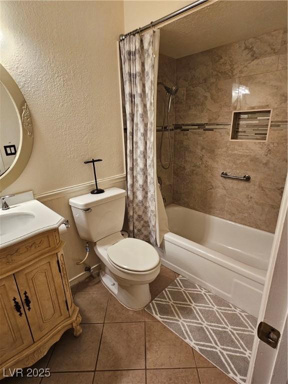 7104 Carrondale Way, Las Vegas, NV 89128 - full bath featuring tile patterned flooring, toilet, shower / bath combo, a textured wall, and vanity