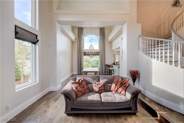 2440 Ping Dr, Henderson, NV 89074 - living room with plenty of natural light, stairway, wood finished floors, baseboards, and a high ceiling