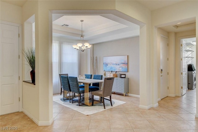 4845 Santo Romeo St, Las Vegas, NV 89135 - dining room featuring a tray ceiling, light tile patterned floors, a chandelier, and baseboards