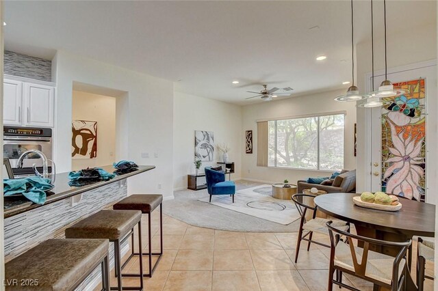 4845 Santo Romeo St, Las Vegas, NV 89135 - living area with light tile patterned floors, a ceiling fan, recessed lighting, baseboards, and light colored carpet