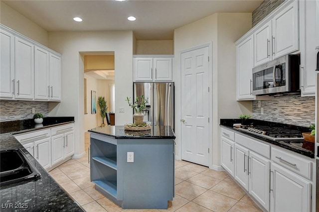 4845 Santo Romeo St, Las Vegas, NV 89135 - kitchen with stainless steel appliances, white cabinets, light tile patterned floors, and recessed lighting