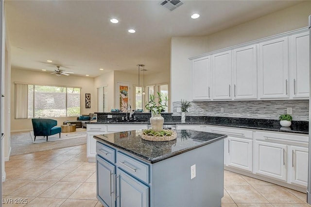 4845 Santo Romeo St, Las Vegas, NV 89135 - kitchen with white cabinetry, a kitchen island, light tile patterned flooring, and recessed lighting