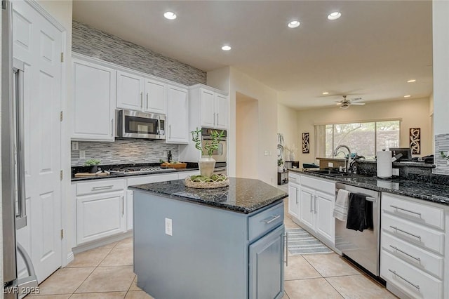 4845 Santo Romeo St, Las Vegas, NV 89135 - kitchen with appliances with stainless steel finishes, a sink, white cabinetry, light tile patterned floors, and recessed lighting