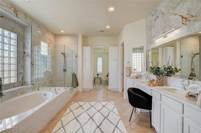 4845 Santo Romeo St, Las Vegas, NV 89135 - full bath with tile patterned floors, a stall shower, a bath, recessed lighting, and double vanity