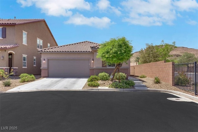 703 Shiva St, Las Vegas, NV 89178 - view of front of home featuring a tile roof, stucco siding, an attached garage, and driveway