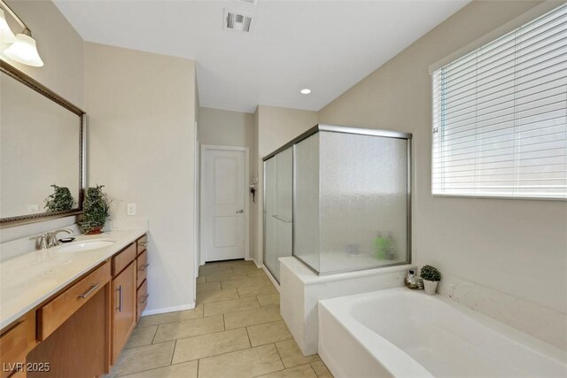 703 Shiva St, Las Vegas, NV 89178 - bathroom with vanity, a stall shower, a garden tub, tile patterned floors, and recessed lighting