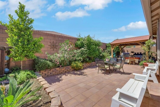 703 Shiva St, Las Vegas, NV 89178 - fenced backyard featuring outdoor dining area, a gazebo, and a patio