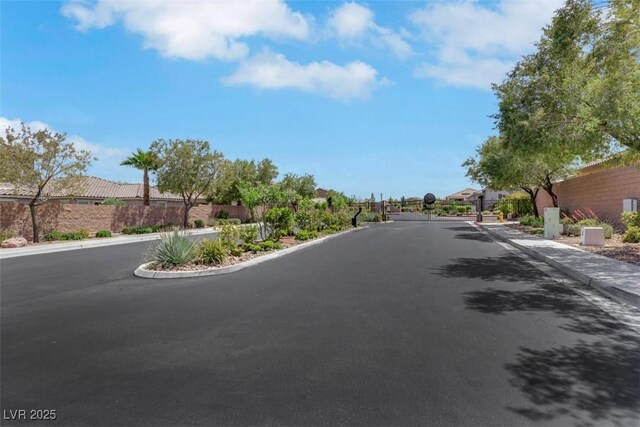 703 Shiva St, Las Vegas, NV 89178 - view of asphalt street with sidewalks, curbs, a gated entry, and a residential view