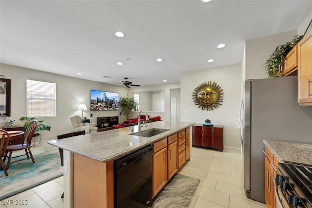 703 Shiva St, Las Vegas, NV 89178 - kitchen featuring dishwasher, a sink, ceiling fan, light stone countertops, and a kitchen island with sink