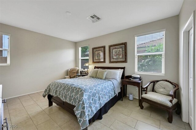 703 Shiva St, Las Vegas, NV 89178 - bedroom with multiple windows, light tile patterned floors, and baseboards
