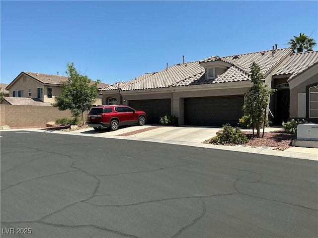 9753 Arrowcrest Ave, Las Vegas, NV 89147 - view of front of property with an attached garage, stucco siding, driveway, and a tiled roof