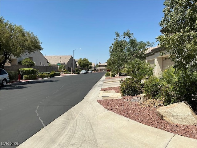 9753 Arrowcrest Ave, Las Vegas, NV 89147 - view of asphalt road with street lighting, a residential view, and sidewalks