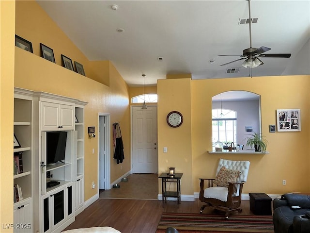 9753 Arrowcrest Ave, Las Vegas, NV 89147 - living area with dark wood-style flooring, baseboards, a ceiling fan, arched walkways, and a high ceiling