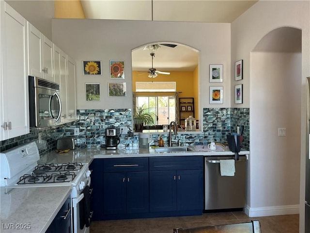 9753 Arrowcrest Ave, Las Vegas, NV 89147 - kitchen featuring stainless steel appliances, a sink, a ceiling fan, backsplash, and dark tile patterned flooring