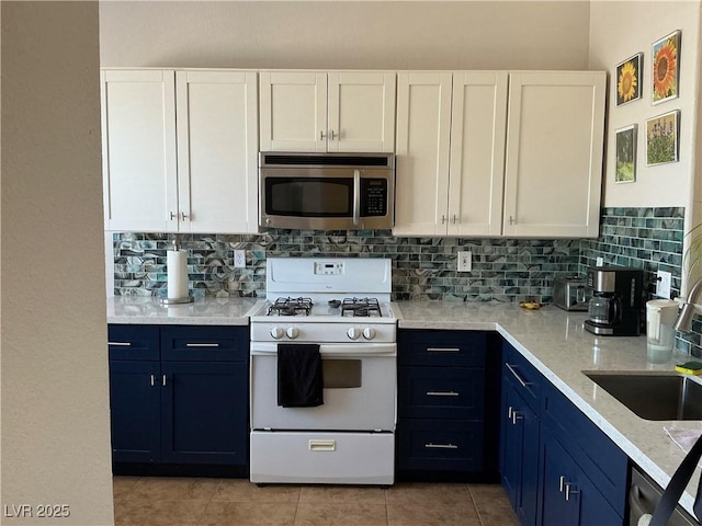 9753 Arrowcrest Ave, Las Vegas, NV 89147 - kitchen with appliances with stainless steel finishes, white cabinets, tasteful backsplash, and blue cabinetry