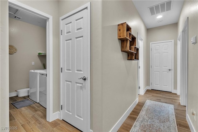 741 Monroe Hill Pl, Henderson, NV 89011 - corridor with washing machine and clothes dryer, wood finished floors, and baseboards