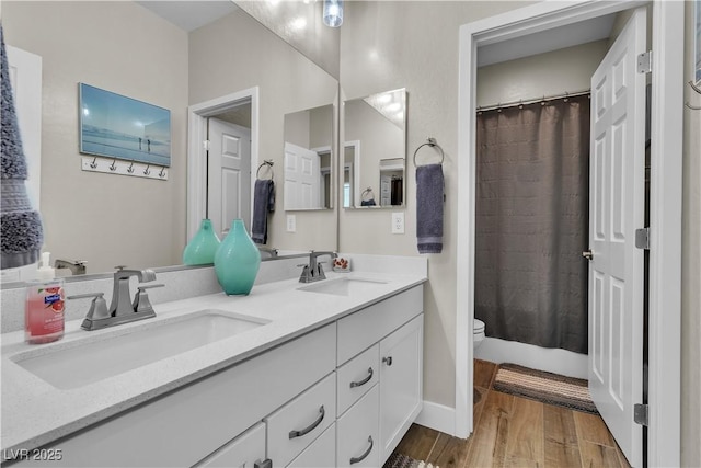 741 Monroe Hill Pl, Henderson, NV 89011 - bathroom featuring wood finished floors, double vanity, toilet, and curtained shower