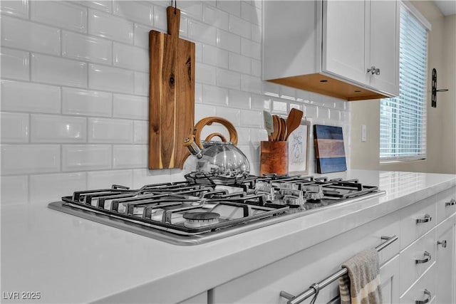 741 Monroe Hill Pl, Henderson, NV 89011 - kitchen view of stainless steel gas cooktop, light countertops, tasteful backsplash, and white cabinets