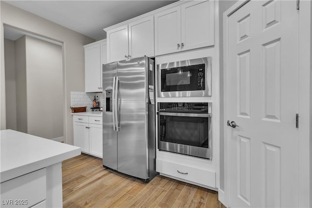 741 Monroe Hill Pl, Henderson, NV 89011 - kitchen featuring stainless steel appliances, light wood-type flooring, light countertops, and white cabinetry