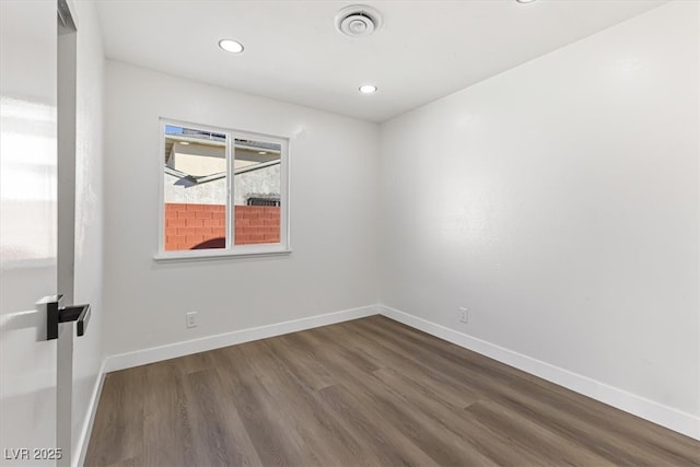 704 Slayton Dr, Las Vegas, NV 89107 - unfurnished room featuring dark wood-style flooring, baseboards, and recessed lighting