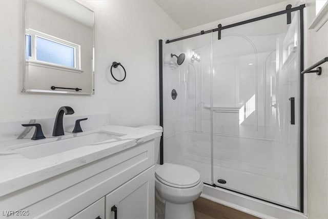 704 Slayton Dr, Las Vegas, NV 89107 - full bathroom featuring a stall shower, toilet, and vanity