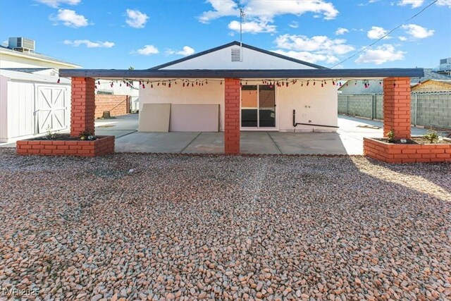 704 Slayton Dr, Las Vegas, NV 89107 - back of house with a patio area and central AC unit