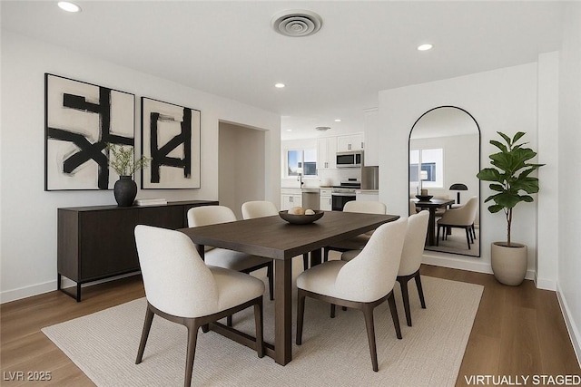 704 Slayton Dr, Las Vegas, NV 89107 - dining area featuring recessed lighting, wood finished floors, and baseboards