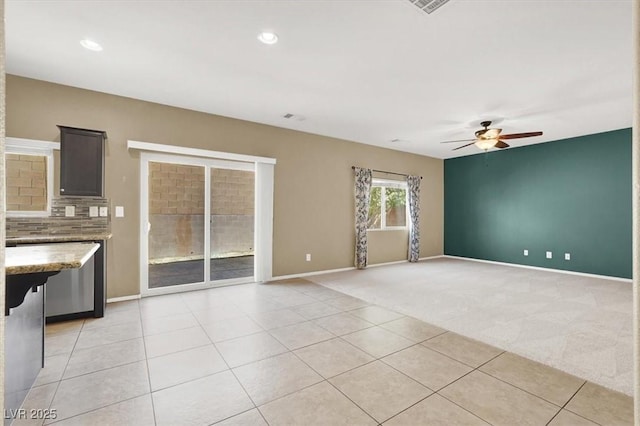 7931 Mineral Peak St, Las Vegas, NV 89166 - unfurnished living room with ceiling fan, baseboards, light carpet, light tile patterned floors, and recessed lighting