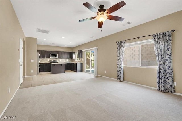 7931 Mineral Peak St, Las Vegas, NV 89166 - unfurnished living room with baseboards, light colored carpet, ceiling fan, and recessed lighting