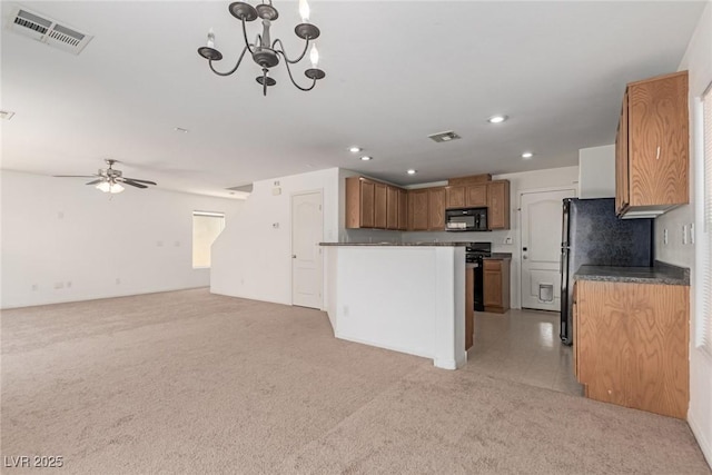 104 Big Cliff Ave, North Las Vegas, NV 89031 - kitchen featuring black appliances, open floor plan, dark countertops, recessed lighting, and brown cabinets
