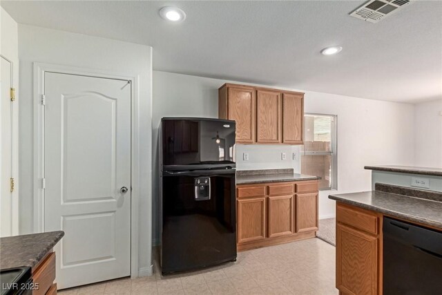 104 Big Cliff Ave, North Las Vegas, NV 89031 - kitchen featuring black appliances, dark countertops, brown cabinets, recessed lighting, and light floors