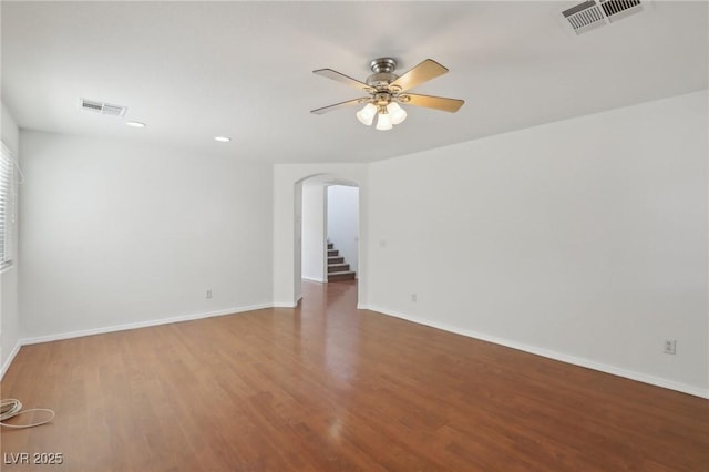 1043 Monte De Oro Ave, Las Vegas, NV 89183 - unfurnished room with arched walkways, a ceiling fan, wood finished floors, baseboards, and recessed lighting