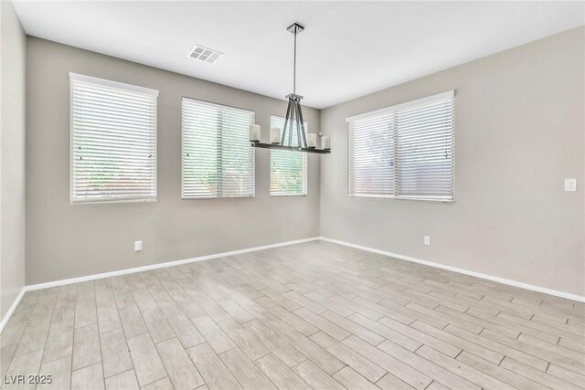 7624 Mallard Bay Ave, Las Vegas, NV 89179 - empty room with baseboards, wood finished floors, and a chandelier