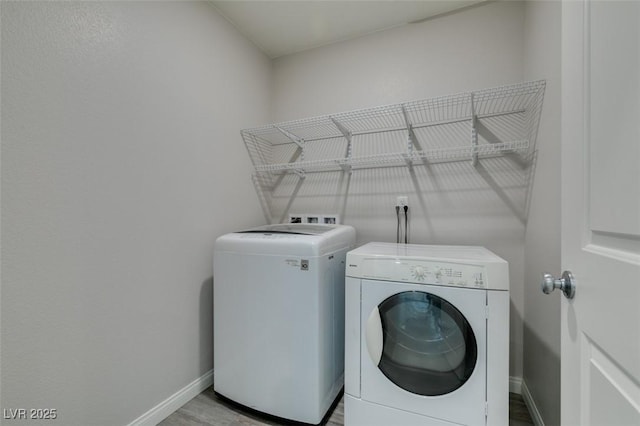 3270 Palindrome Ave, Henderson, NV 89044 - laundry room featuring washing machine and clothes dryer, baseboards, and wood finished floors