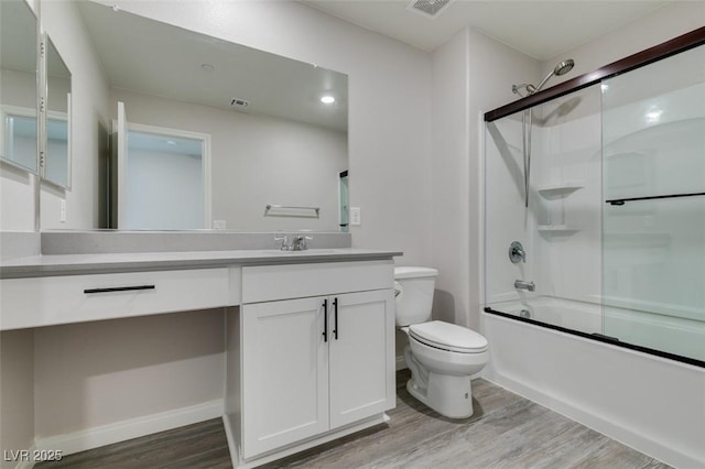 3270 Palindrome Ave, Henderson, NV 89044 - full bathroom with wood finished floors, toilet, vanity, and bath / shower combo with glass door