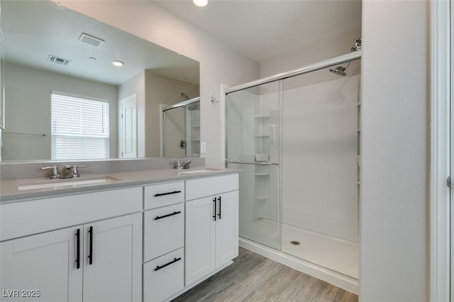 3270 Palindrome Ave, Henderson, NV 89044 - bathroom with a stall shower, double vanity, and wood finished floors