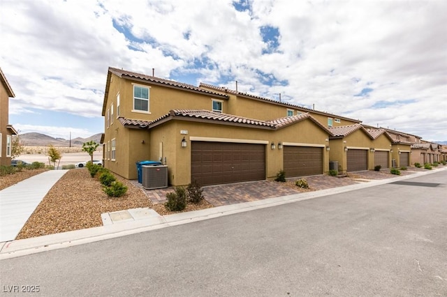3270 Palindrome Ave, Henderson, NV 89044 - view of front of house with stucco siding, central air condition unit, a tile roof, and an attached garage
