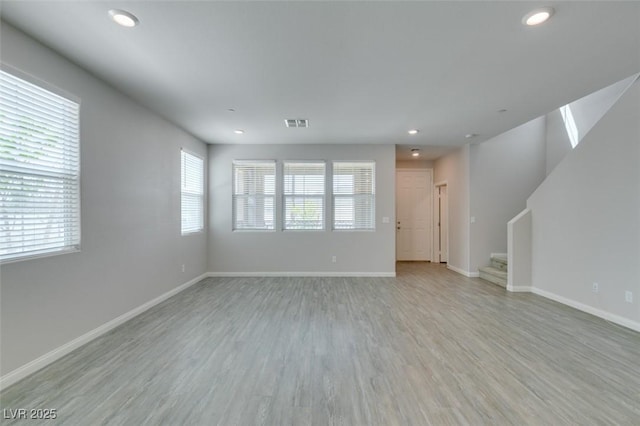3270 Palindrome Ave, Henderson, NV 89044 - unfurnished living room featuring light wood-style flooring, recessed lighting, stairway, and baseboards