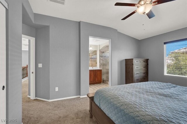 10845 Drake Ridge Ave, Las Vegas, NV 89166 - carpeted bedroom featuring baseboards, vaulted ceiling, ceiling fan, and connected bathroom
