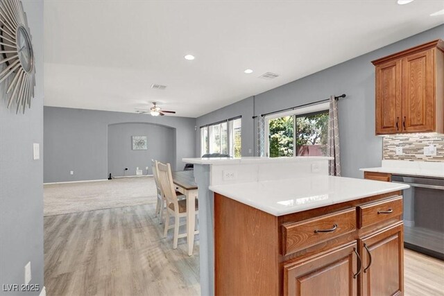 10845 Drake Ridge Ave, Las Vegas, NV 89166 - kitchen featuring stainless steel dishwasher, recessed lighting, a ceiling fan, brown cabinets, and light countertops