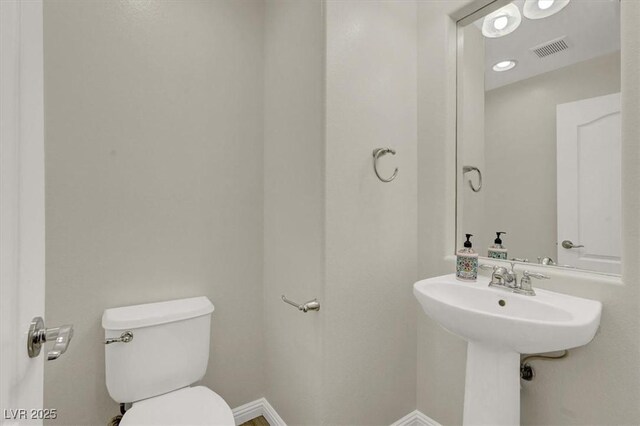 10845 Drake Ridge Ave, Las Vegas, NV 89166 - half bathroom featuring toilet and baseboards