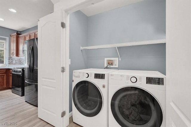10845 Drake Ridge Ave, Las Vegas, NV 89166 - laundry room featuring independent washer and dryer, light wood-style flooring, and recessed lighting