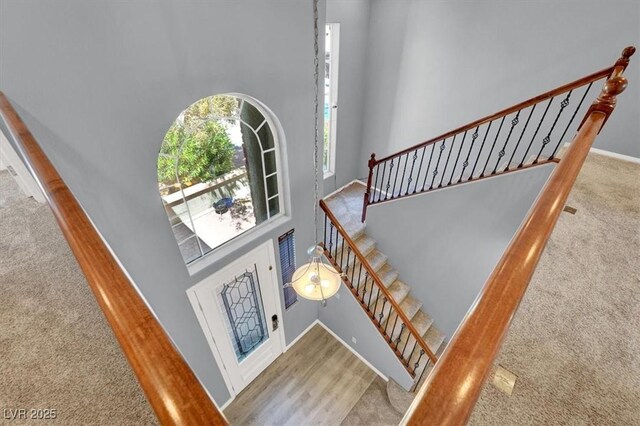 10845 Drake Ridge Ave, Las Vegas, NV 89166 - staircase with carpet flooring, a towering ceiling, and baseboards