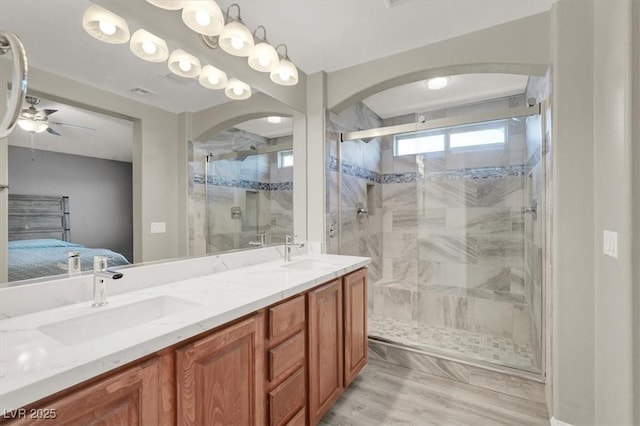 10845 Drake Ridge Ave, Las Vegas, NV 89166 - ensuite bathroom with a shower stall, double vanity, ceiling fan, and wood finished floors