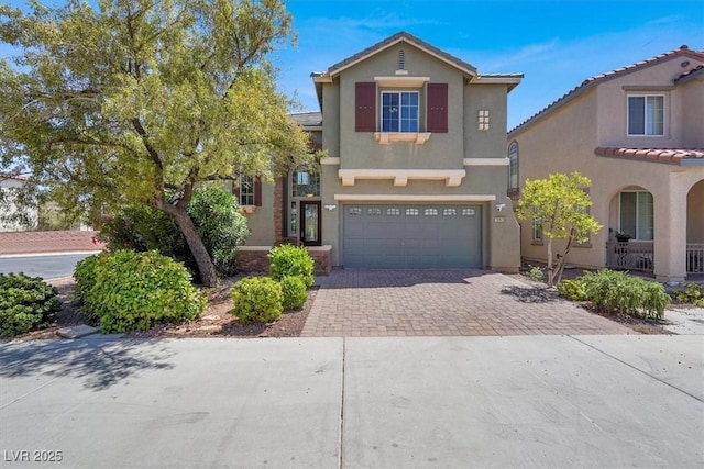 10845 Drake Ridge Ave, Las Vegas, NV 89166 - view of front of home featuring decorative driveway, an attached garage, and stucco siding