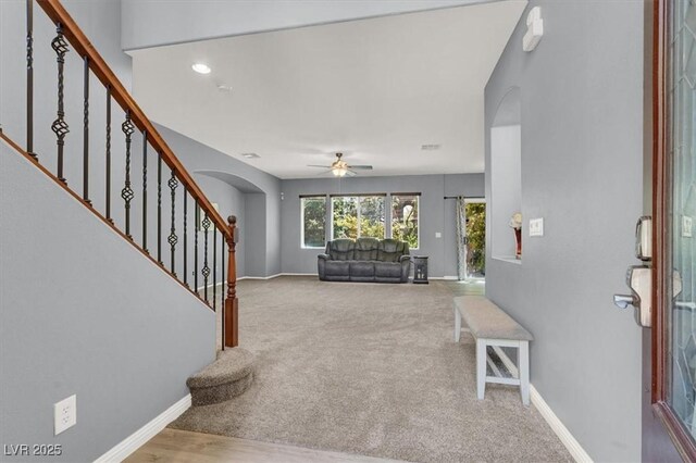 10845 Drake Ridge Ave, Las Vegas, NV 89166 - carpeted foyer entrance featuring arched walkways, ceiling fan, stairway, and baseboards