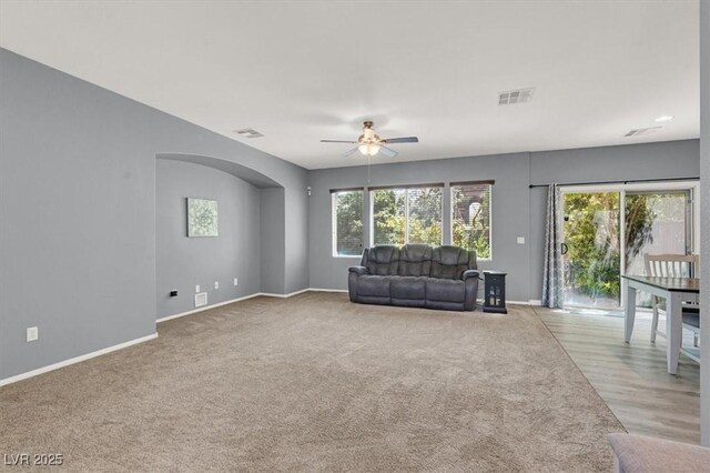 10845 Drake Ridge Ave, Las Vegas, NV 89166 - living room featuring ceiling fan, plenty of natural light, arched walkways, and baseboards