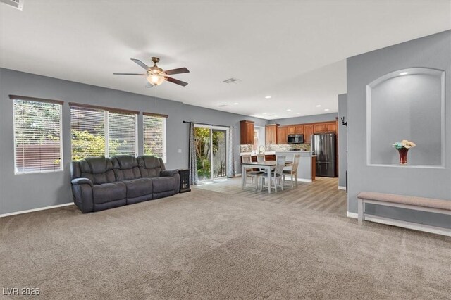 10845 Drake Ridge Ave, Las Vegas, NV 89166 - living room with ceiling fan, light colored carpet, baseboards, and recessed lighting